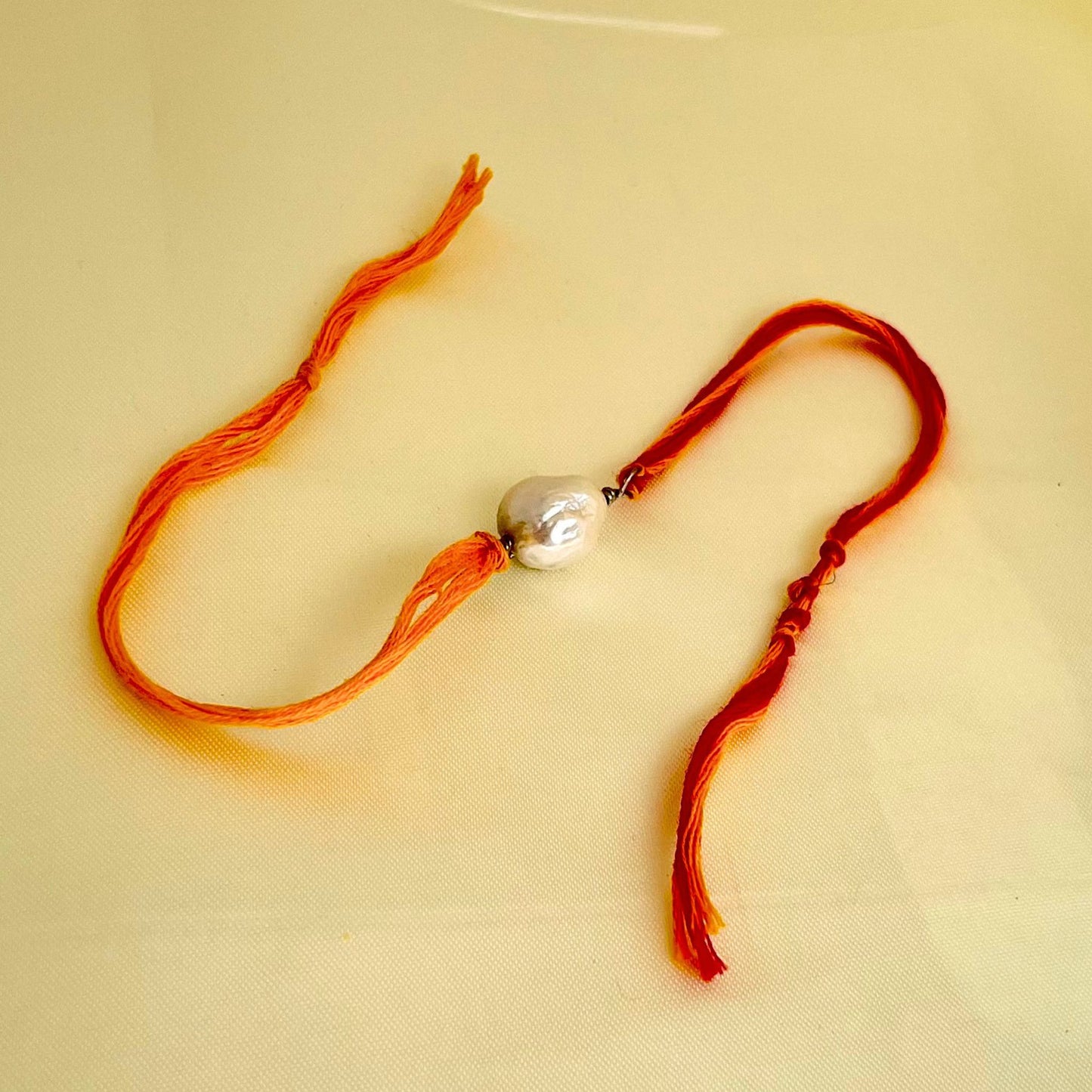 Buy Real Single Baroque Pearl Rakhi in 92.5 silver & Mouli Thread- CherishBox