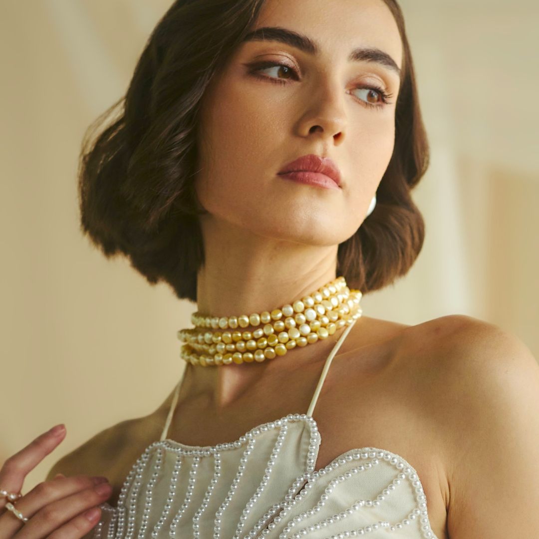 Woman wearing a four-strand champagne freshwater pearl layered choker necklace by CherishBox