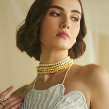 Woman wearing a four-strand champagne freshwater pearl layered choker necklace by CherishBox