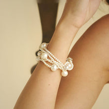 Élan five-strand freshwater pearl bracelet with large accent pearls, worn on a model's wrist - CherishBox